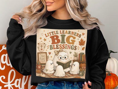 Little Learners Big Blessings text with ghosts reading on a plaid blanket.