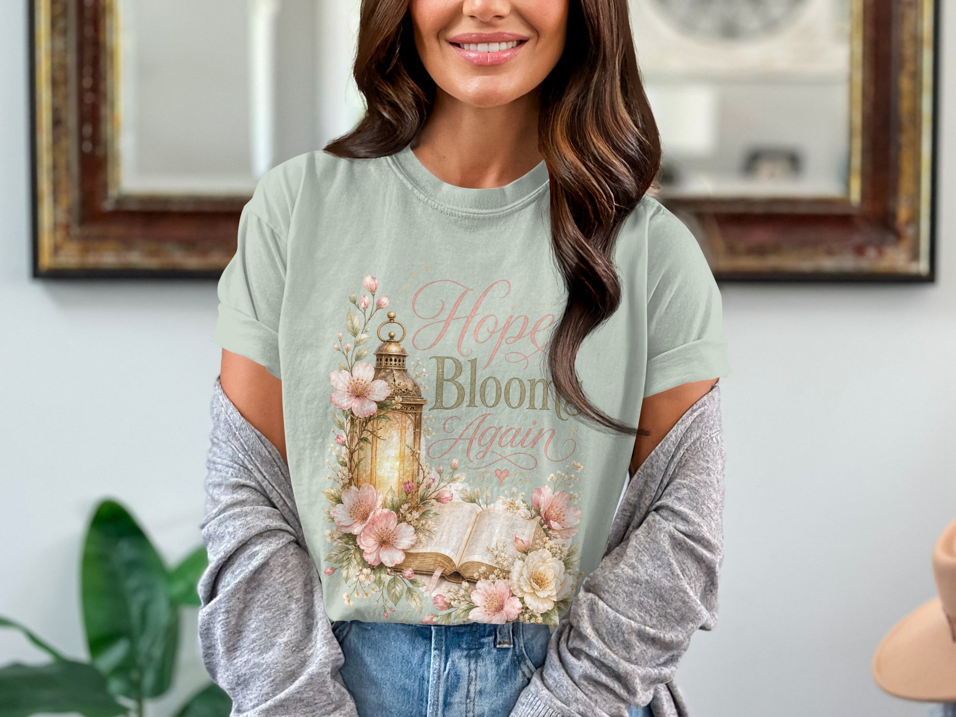 Light green t-shirt with "Hope Blooms Again" text and floral lantern design.