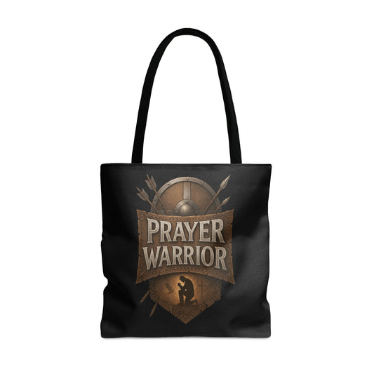 Black tote bag with "PRAYER WARRIOR" design featuring a shield and kneeling figure.