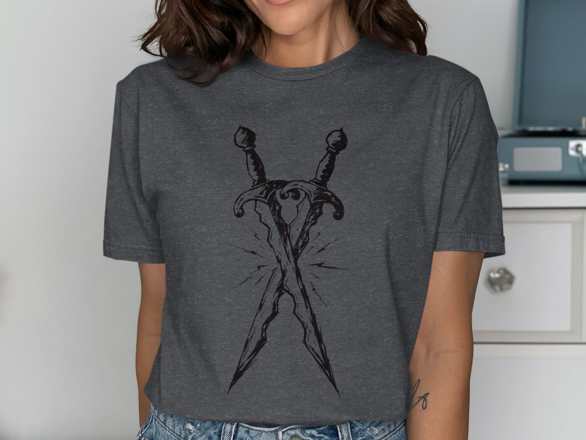 Dark grey t-shirt with crossed daggers illustration.