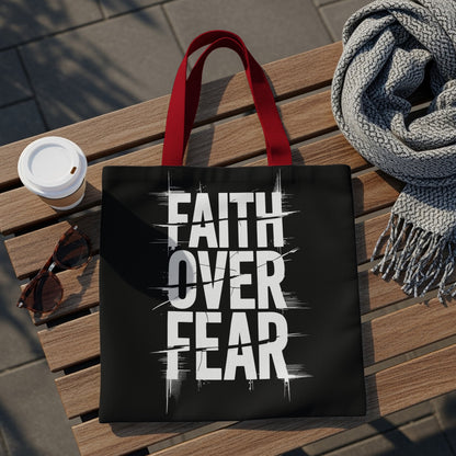 Black tote bag with red straps featuring "FAITH OVER FEAR" in white text.