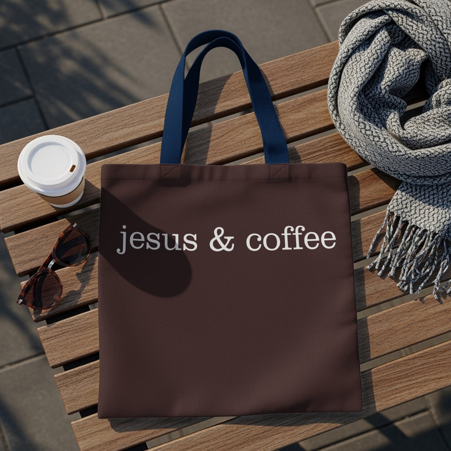 Brown tote bag with white text "jesus & coffee" and blue straps.