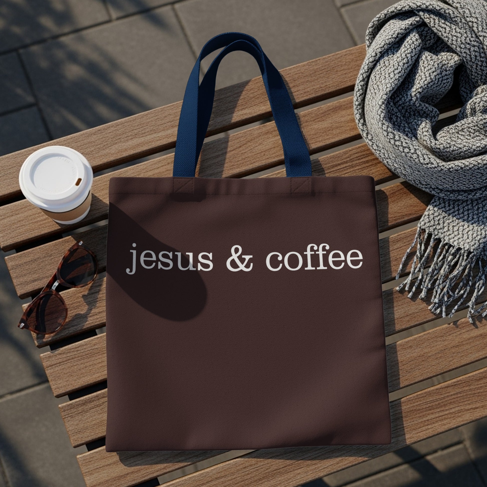 Brown tote bag with white text "jesus & coffee" and blue straps.
