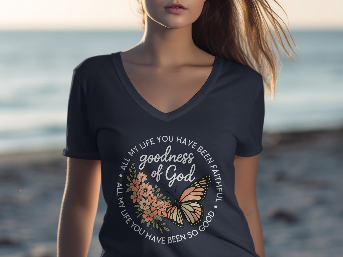 Dark t-shirt with butterfly and floral design, text reads "goodness of God"