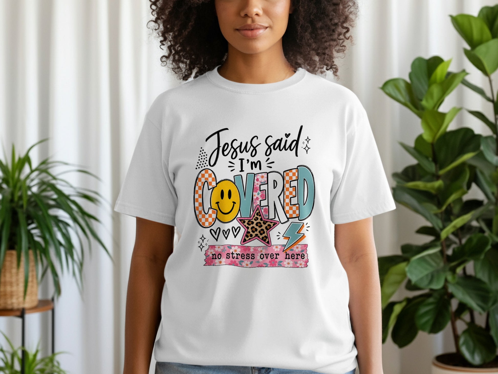 White t-shirt with "Jesus said I'm COVERED" and "no stress over here" graphic.