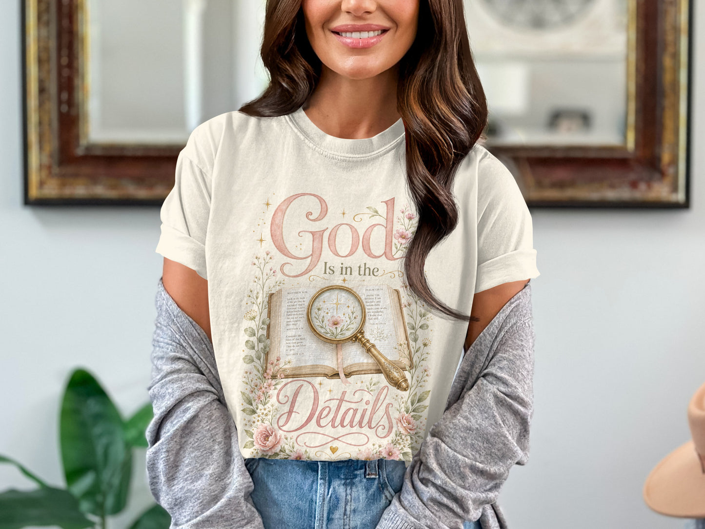 Cream t-shirt with "God Is in the Details" and biblical verses design.