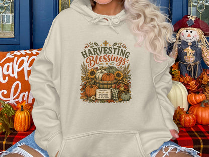 Cream hoodie with "Harvesting Blessings" and Psalm 107:1 graphic.