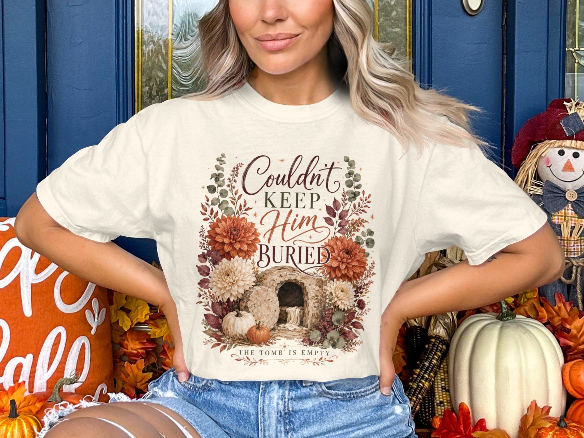 Cream t-shirt with floral graphic reading "Couldn't Keep Him Buried."