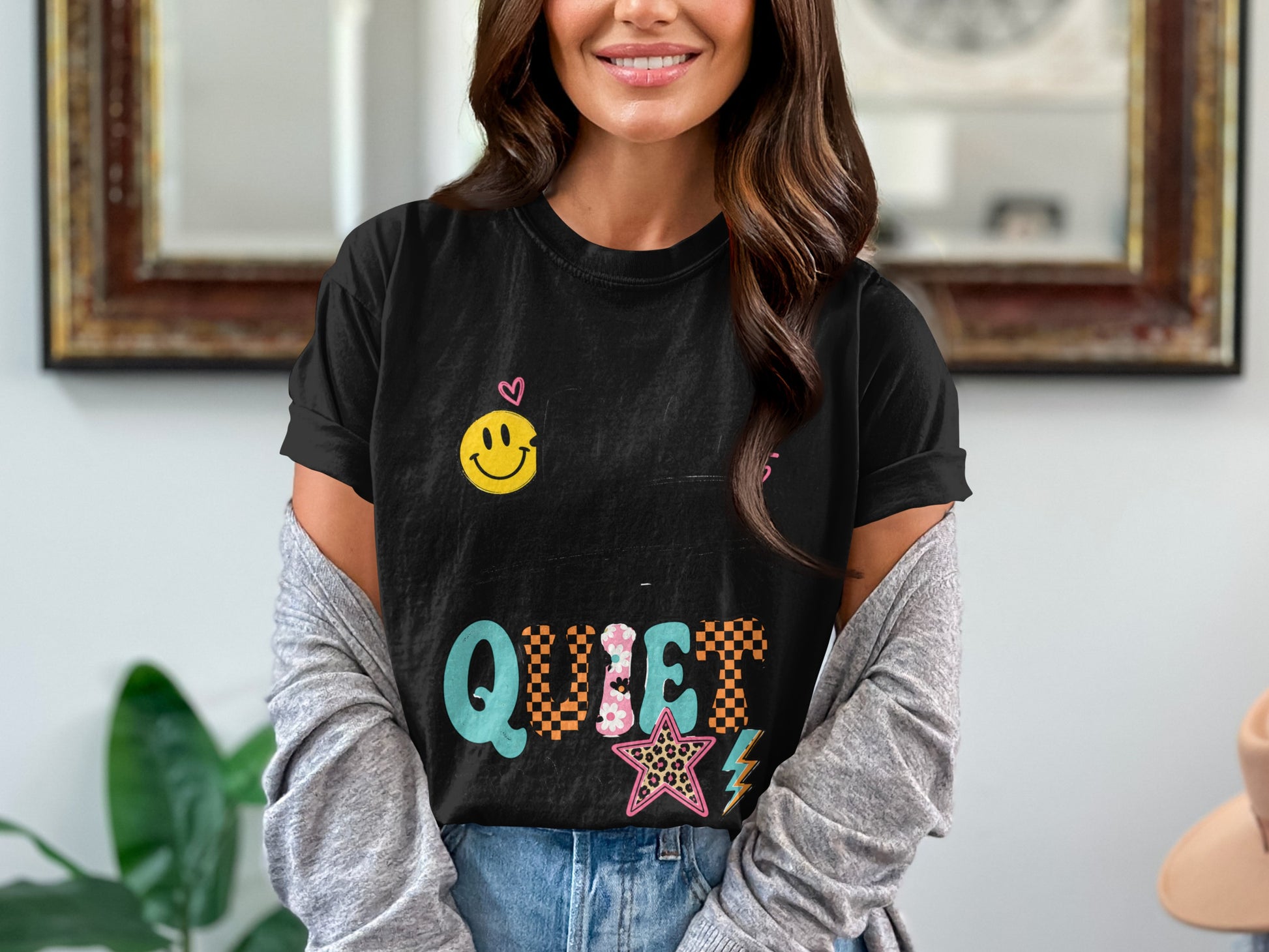 Black t-shirt with a smiley face and the word "QUIET" with colorful graphics.