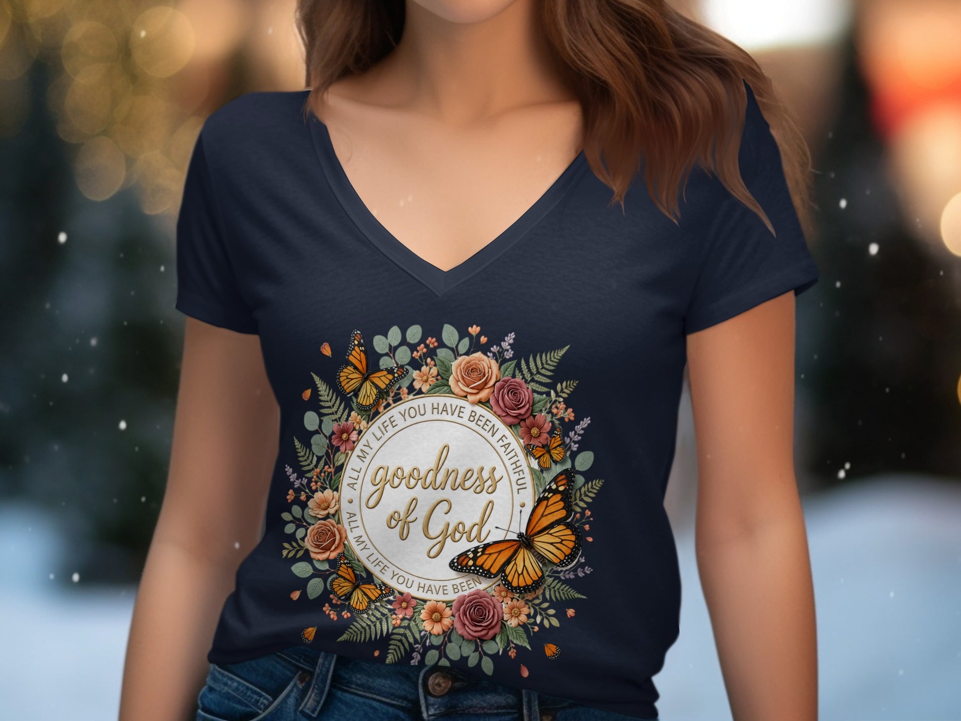 Navy v-neck t-shirt with "Goodness of God" text within a floral and butterfly wreath.