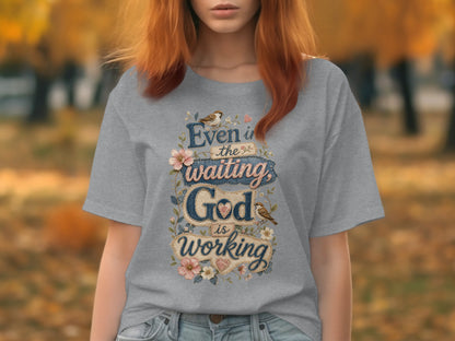Grey t-shirt with "Even in the waiting God is working" text and floral accents.