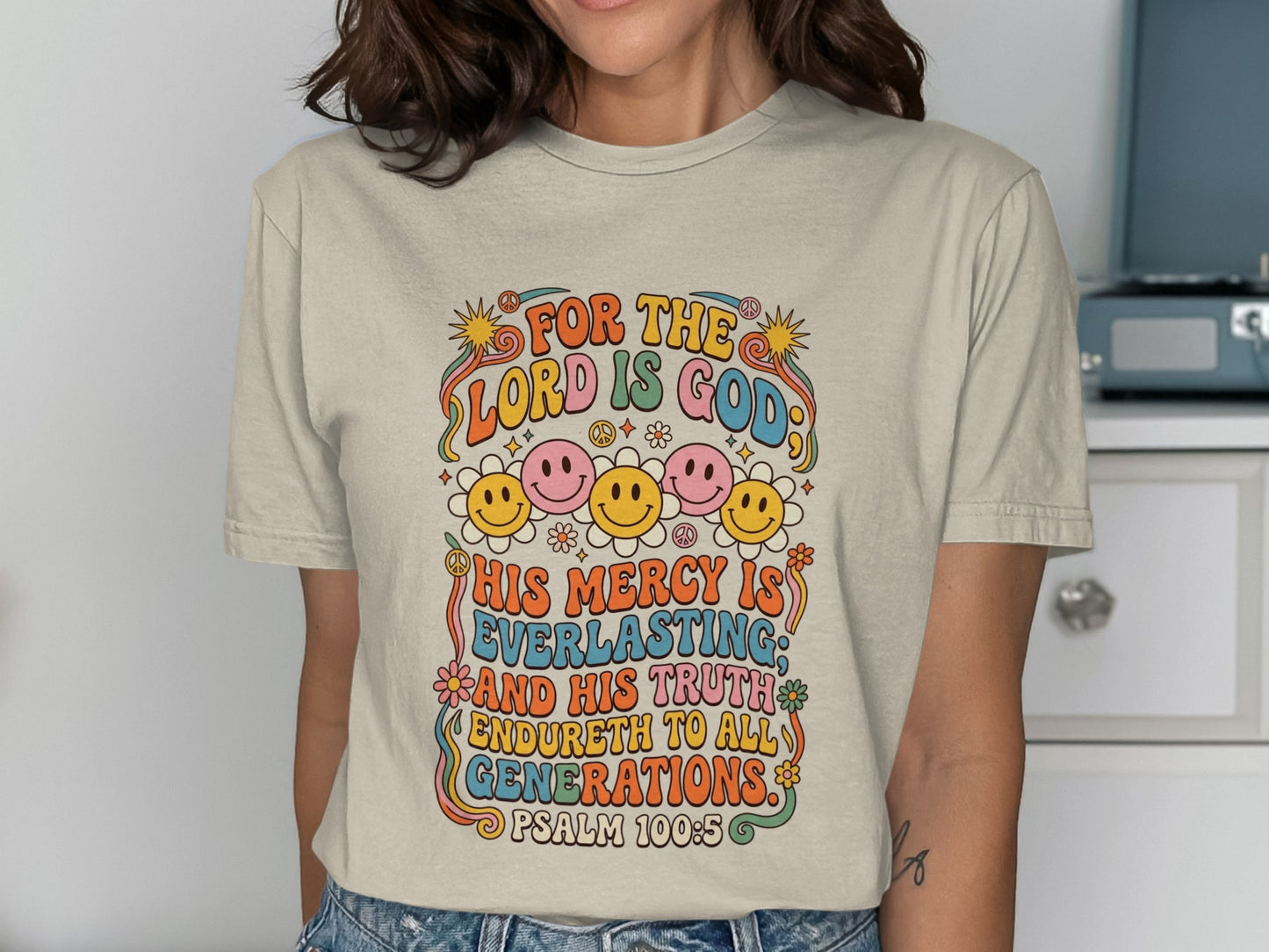 T-shirt with colorful retro text and smiley faces, "For the Lord is God" Psalm 100:5.