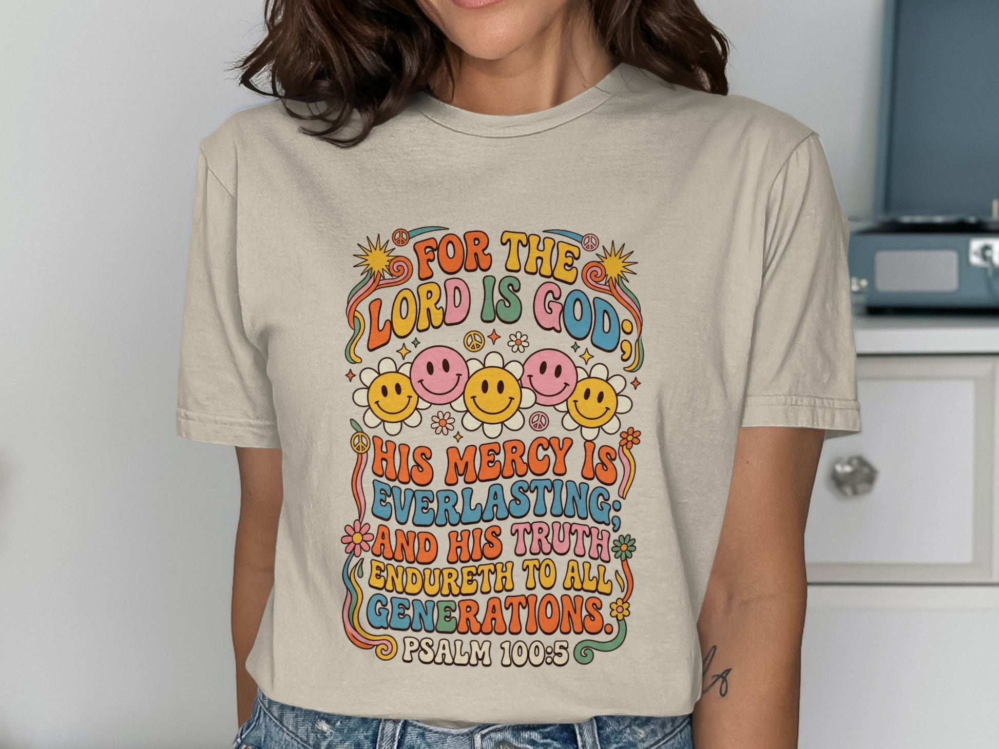 T-shirt with colorful retro text and smiley faces, "For the Lord is God" Psalm 100:5.