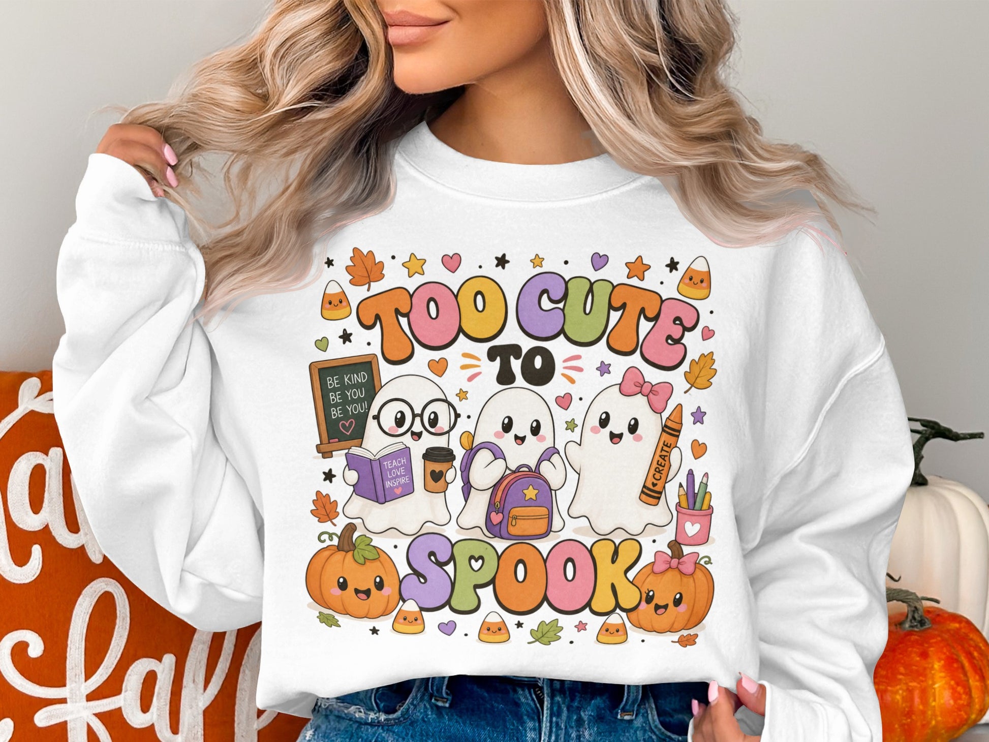 White sweatshirt with "Too Cute to Spook" and cute ghosts with pumpkins and candy corn.