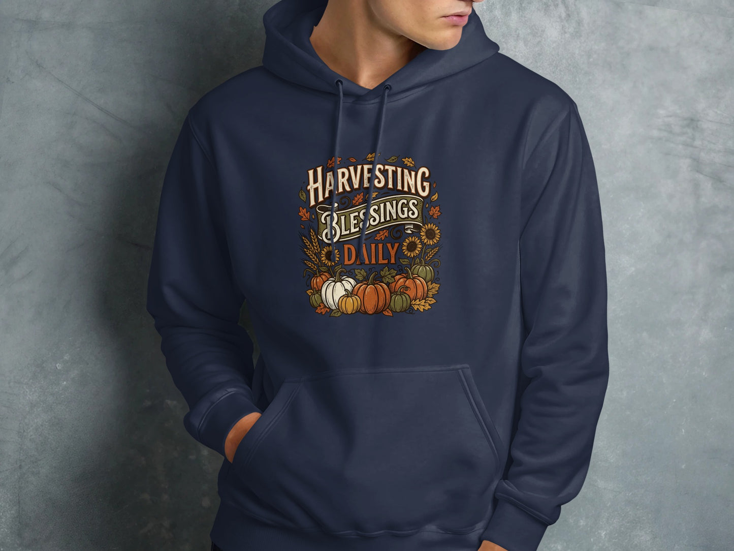 Navy blue hoodie with "Harvesting Blessings Daily" text and fall graphics.