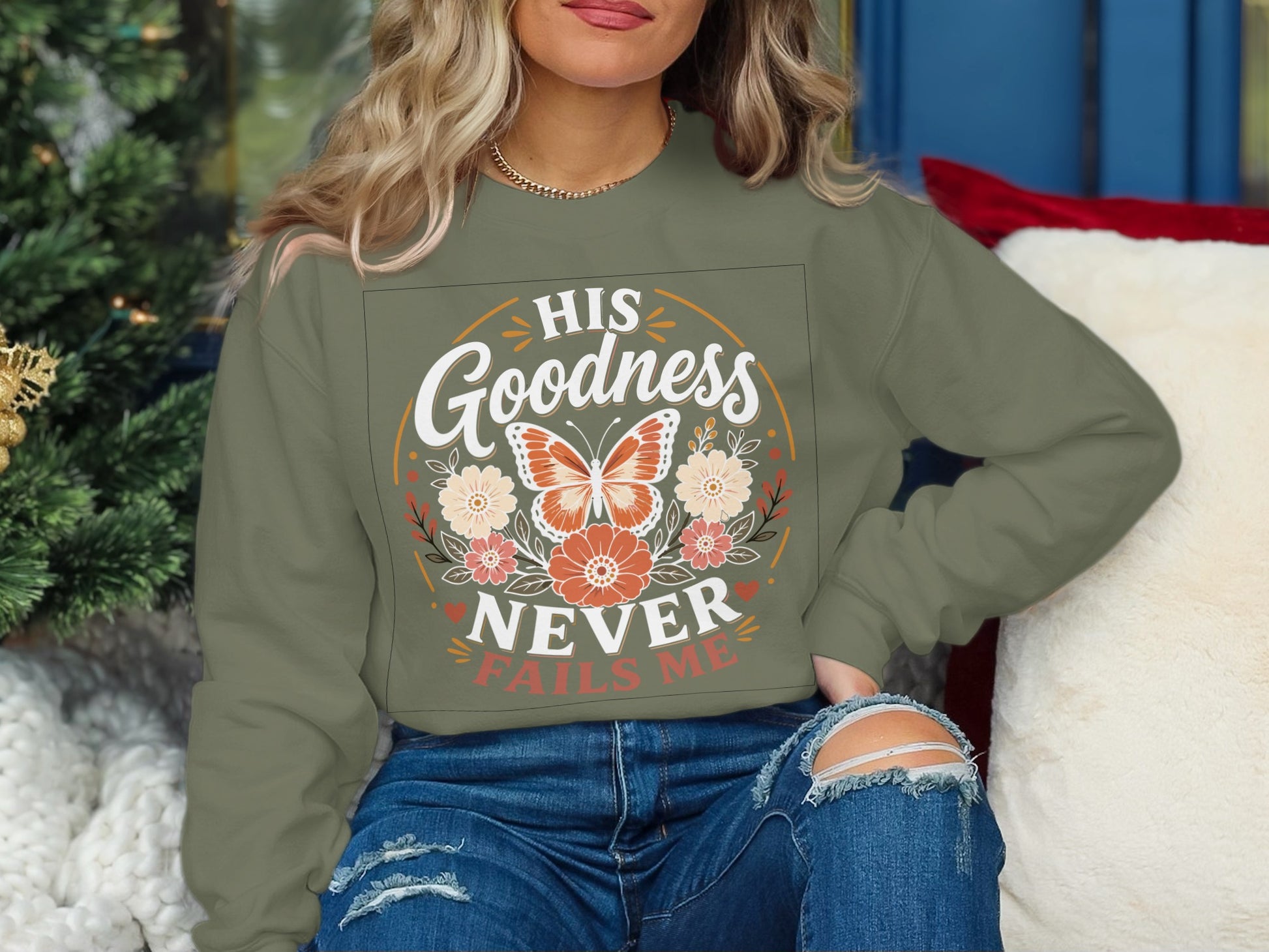 Green sweatshirt with butterfly and floral graphic "His Goodness Never Fails Me".