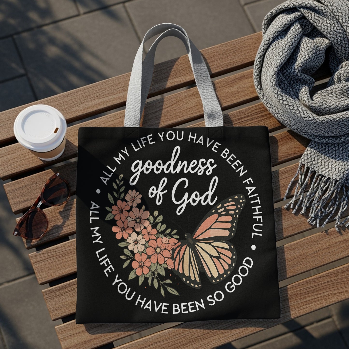 Black tote bag with butterfly and flowers design, "goodness of God" text.