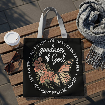 Black tote bag with butterfly and flowers design, "goodness of God" text.