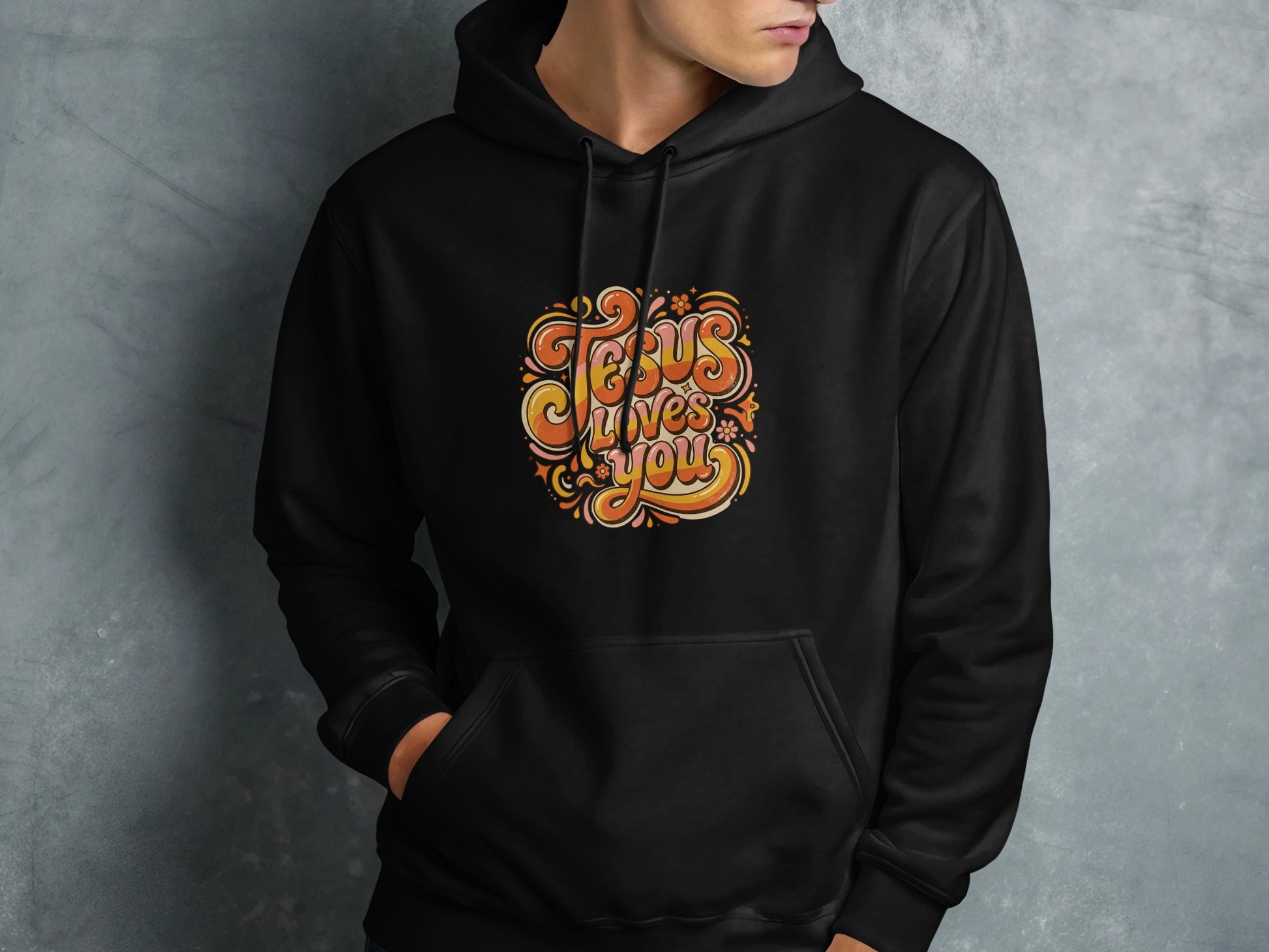 Black hoodie with colorful "Jesus Loves You" text graphic on chest.