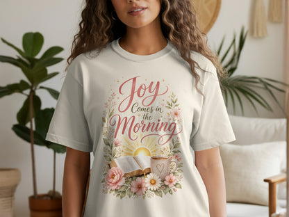Cream t-shirt with "Joy Comes in the Morning" text, bible, and flowers.