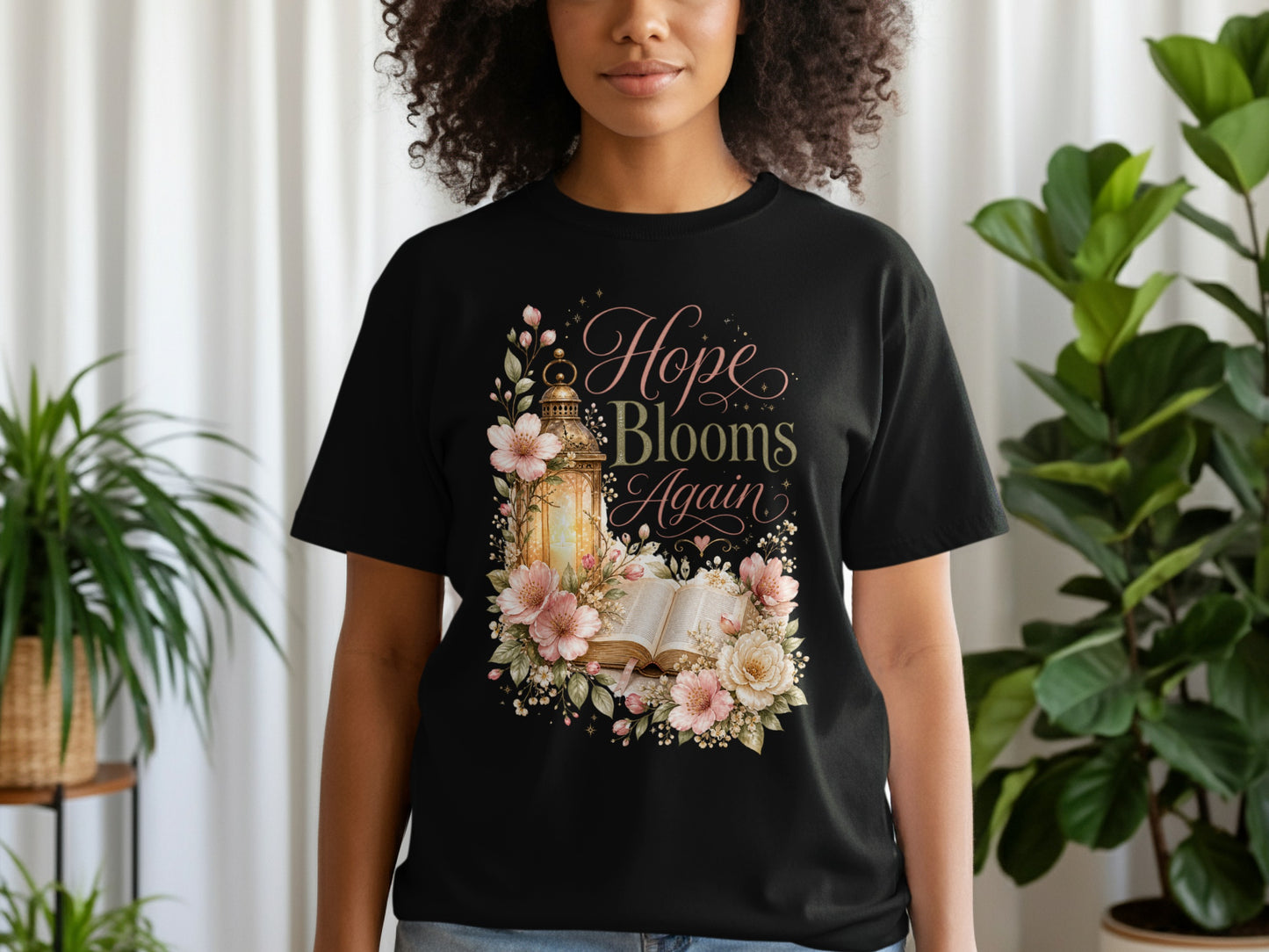 Black t-shirt with "Hope Blooms Again" text and floral lantern design.