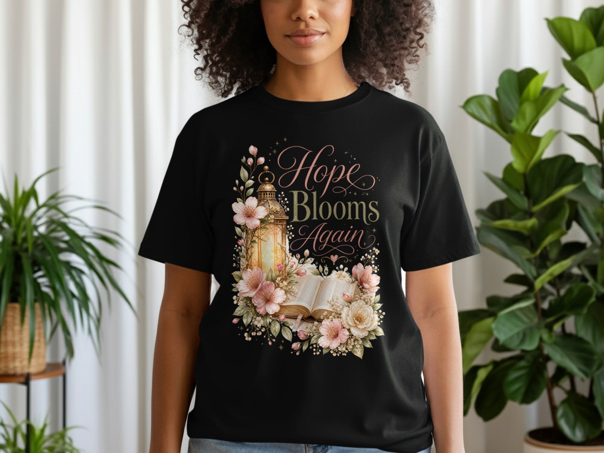 Black t-shirt with "Hope Blooms Again" text and floral lantern design.
