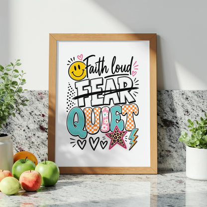 Framed art with text "Faith loud" over "Fear" crossed out and "Quiet" creatively displayed.