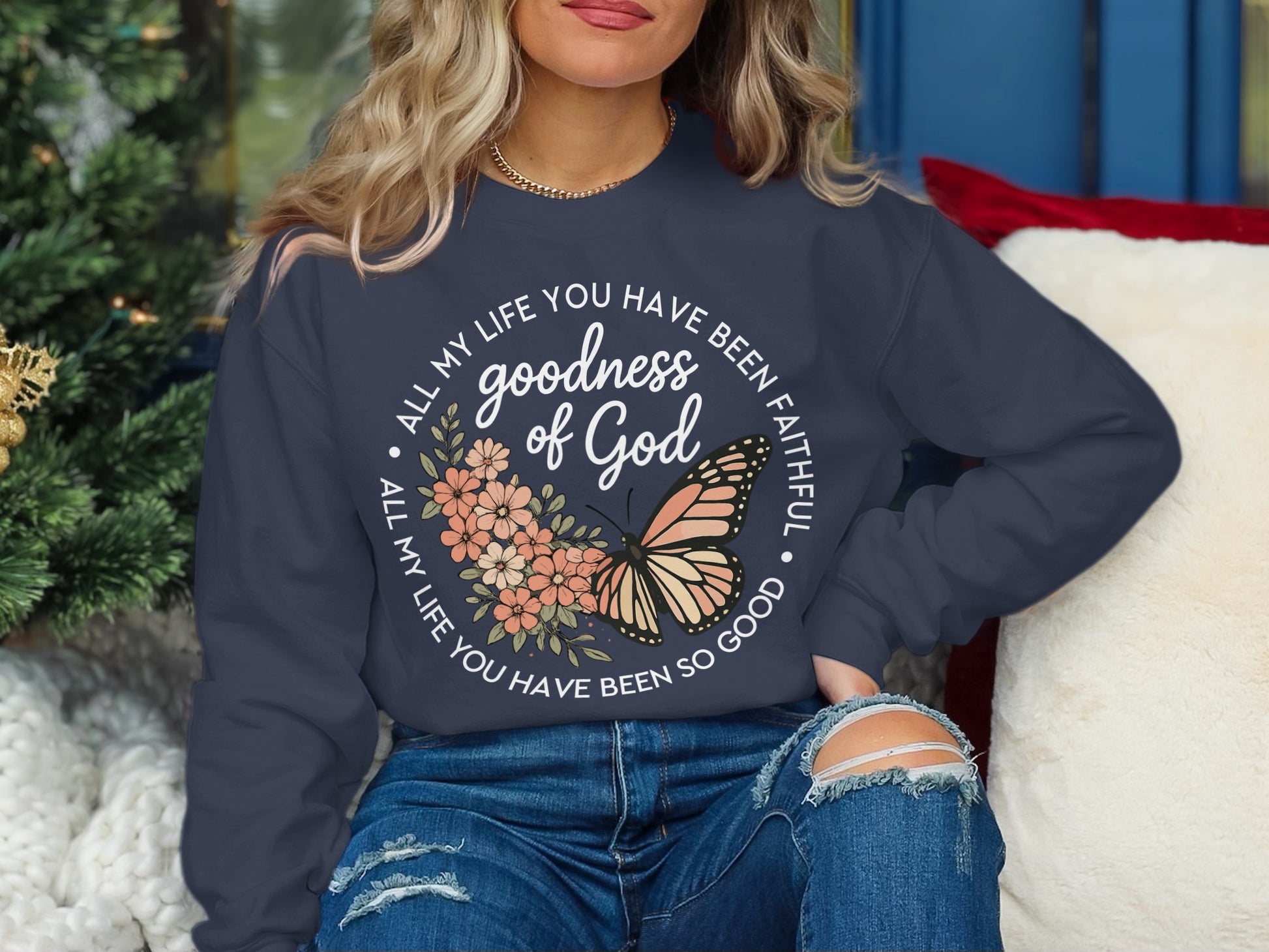 Navy sweatshirt with "Goodness of God" text and butterfly graphic.