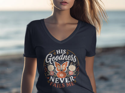 Navy v-neck t-shirt with "HIS GOODNESS NEVER FAILS ME" text and floral butterfly design.