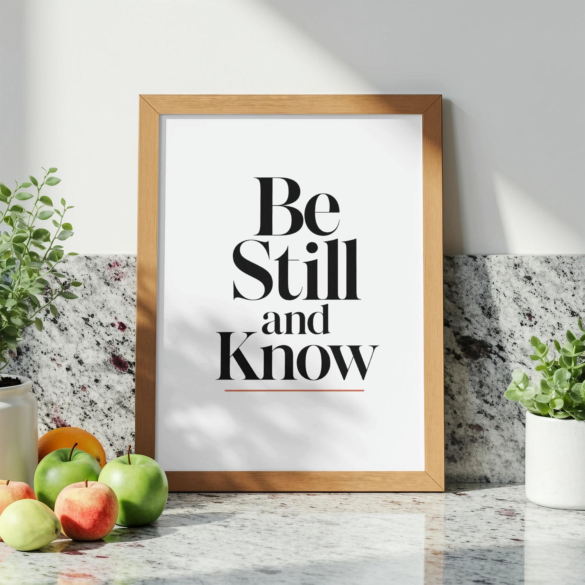 Wooden framed print with "Be Still and Know" text, surrounded by fruit and plants.