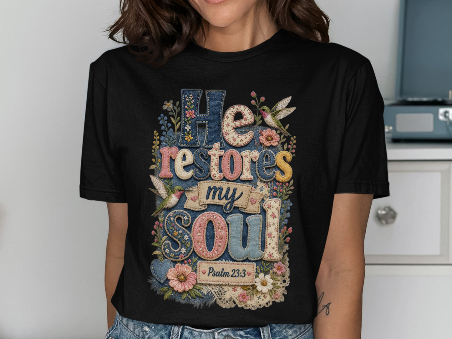 Black t-shirt with "He restores my soul" and floral hummingbird design.