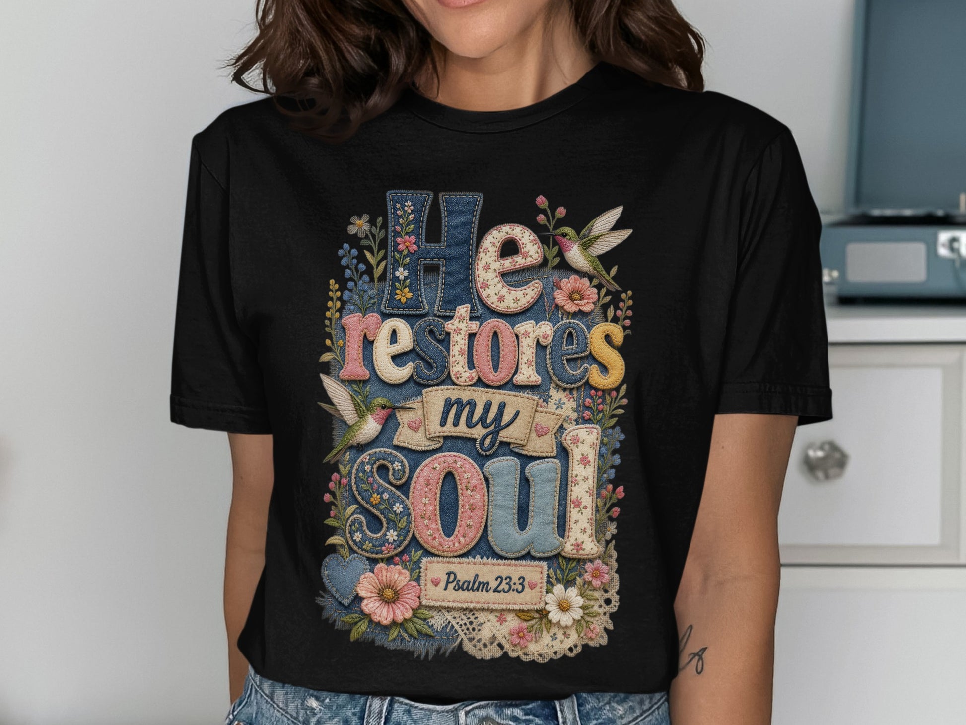 Black t-shirt with "He restores my soul" and floral hummingbird design.