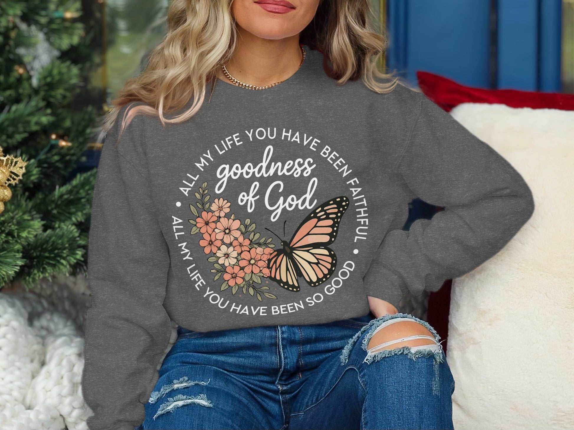 Gray sweatshirt with "goodness of God" and butterfly design.