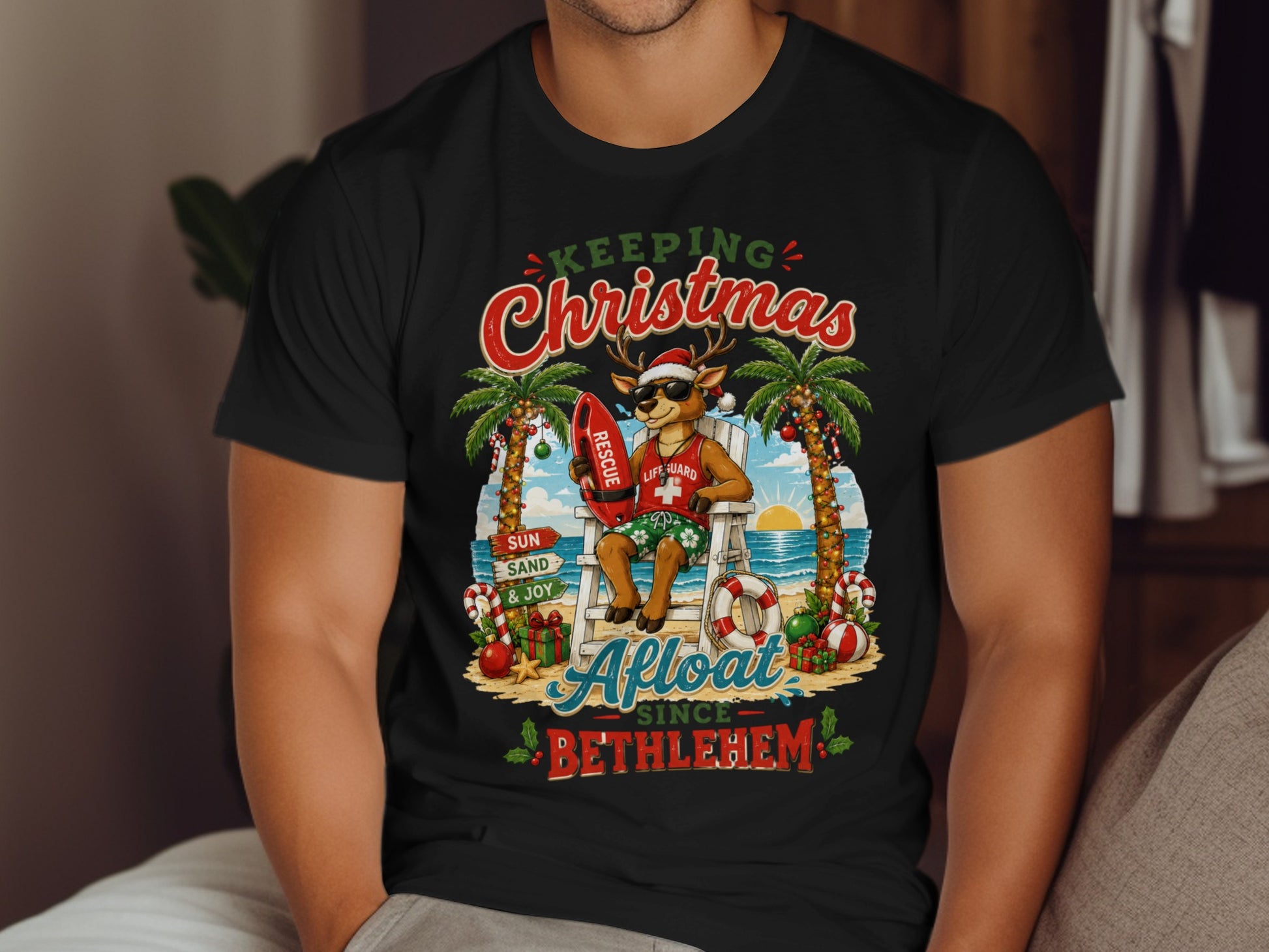 Man wearing a black t-shirt with a "Keeping Christmas Afloat Since Bethlehem" graphic.