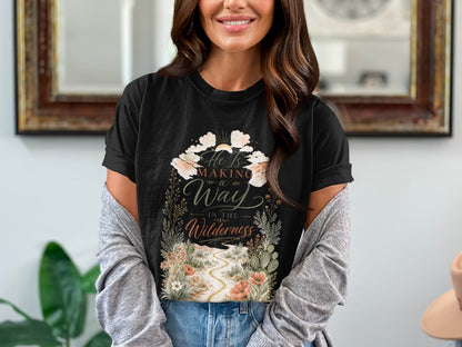 Black t-shirt with floral desert landscape and text "He Is Making a Way In The Wilderness".