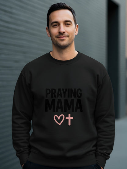 Black sweatshirt with "PRAYING MAMA" text and a pink heart and cross graphic.