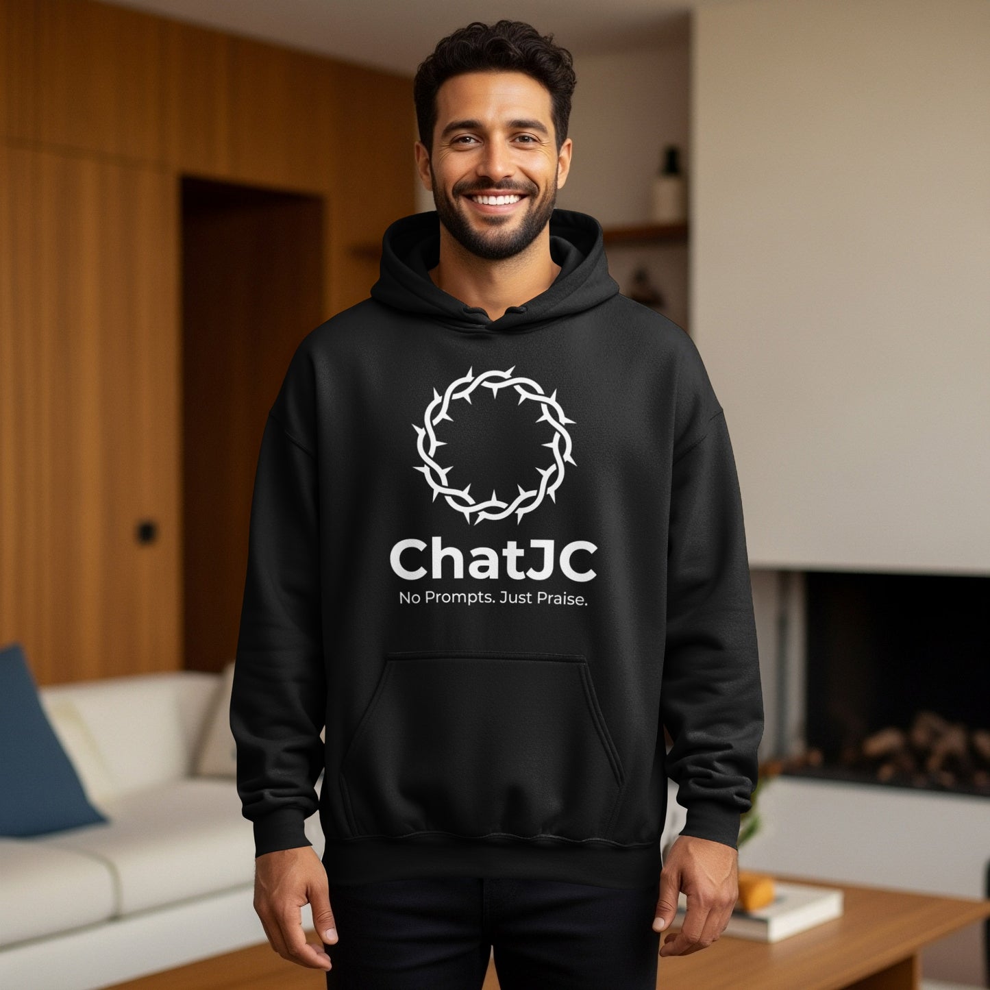 Man wearing a black hoodie with a white crown of thorns and "ChatJC No Prompts. Just Praise."