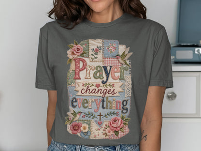 Gray t-shirt with "Prayer changes everything" text and floral patchwork design.