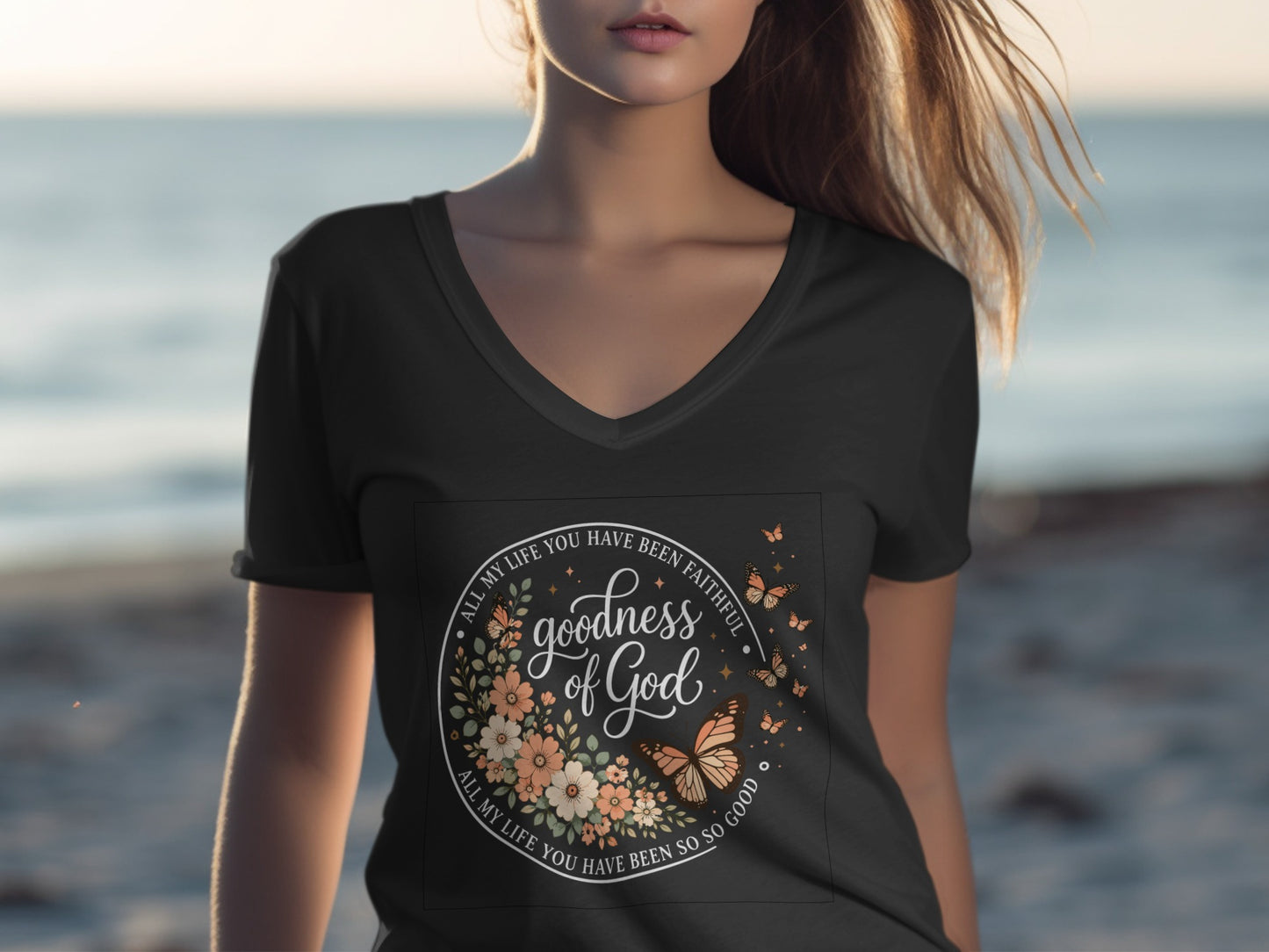 Black v-neck t-shirt with floral wreath and "goodness of God" text.