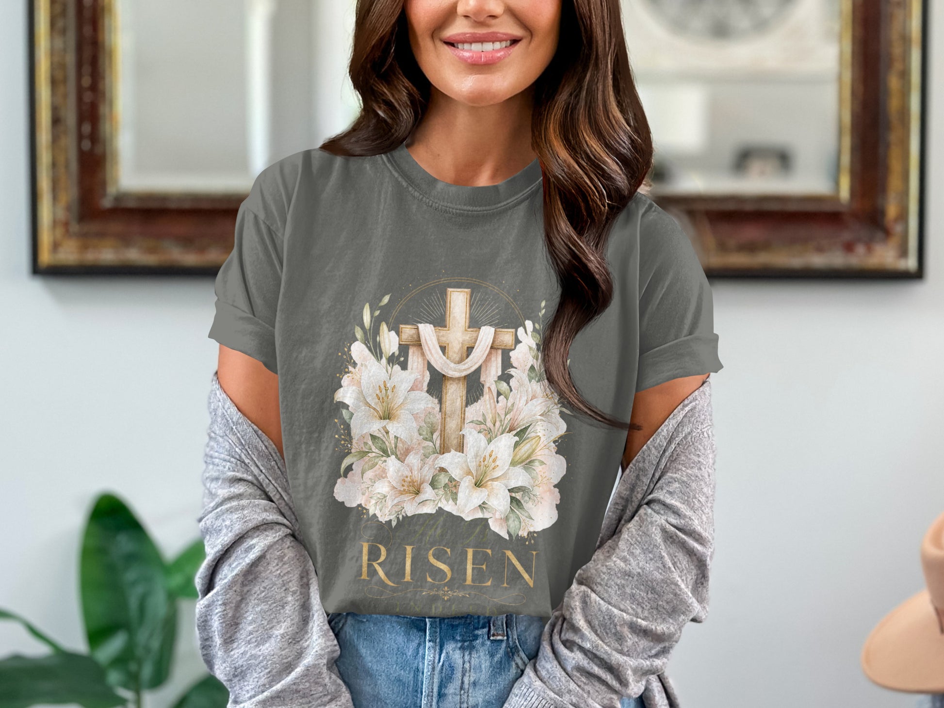 Dark grey t-shirt with a wooden cross, lilies, and the word "RISEN" in gold.