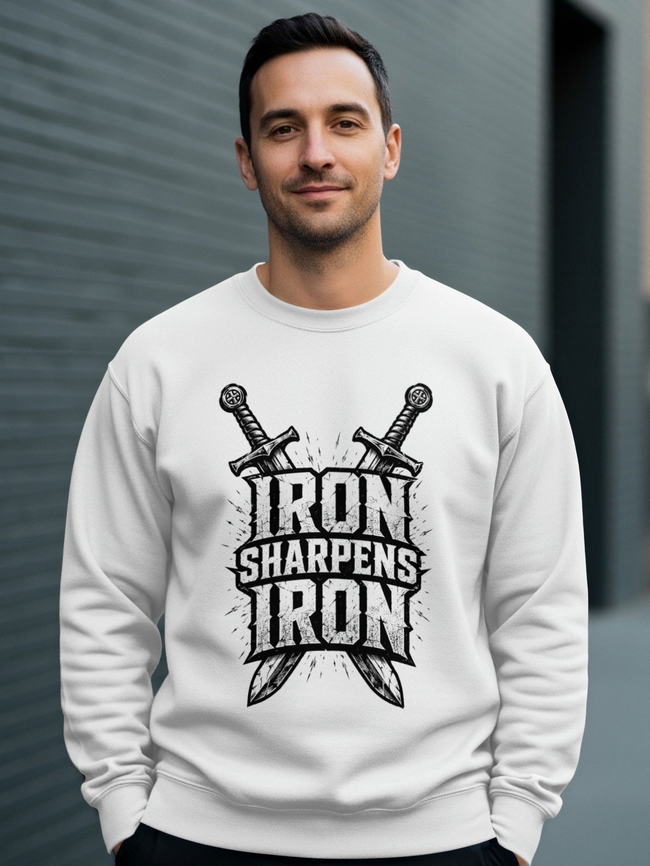 White sweatshirt with "Iron Sharpens Iron" text and crossed swords graphic.