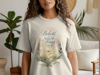 T-shirt with watercolor floral design and text "Behold, I make all things new".