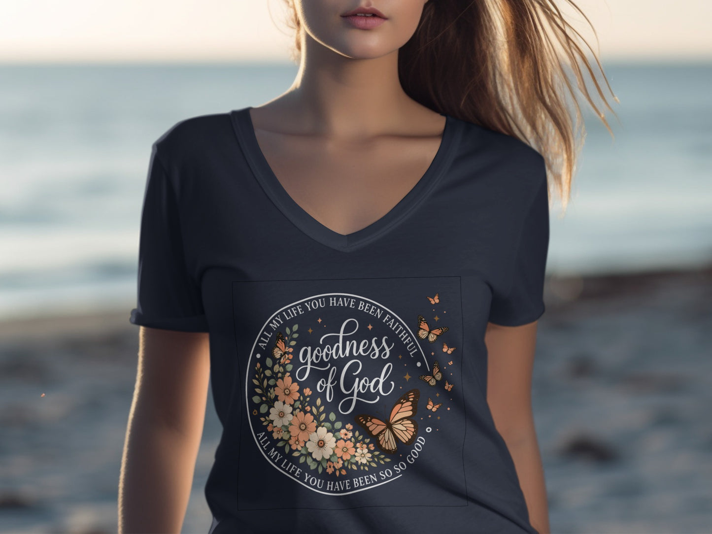 Dark blue t-shirt with floral and butterfly design, text "goodness of God".