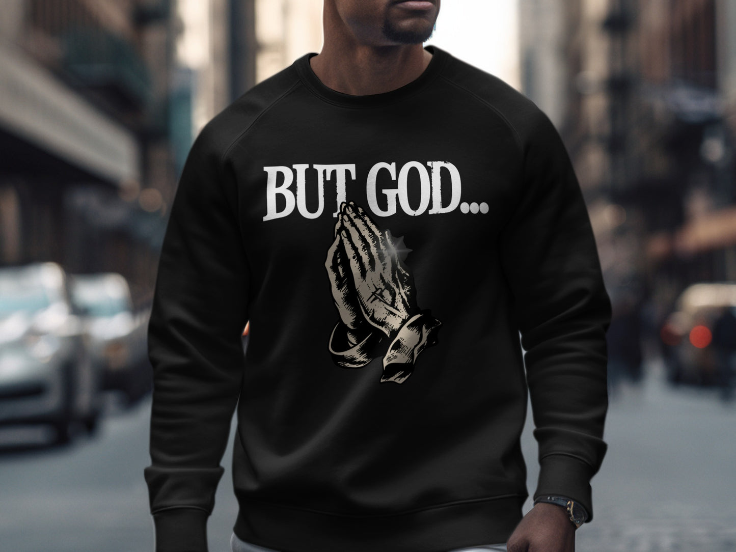 Black sweatshirt with "BUT GOD..." and praying hands graphic.