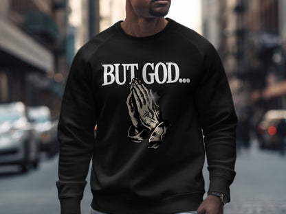 Black sweatshirt with "BUT GOD..." and praying hands graphic.
