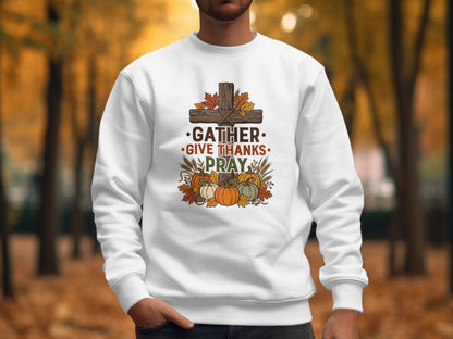 White sweatshirt with "Gather. Give Thanks. Pray." and autumn harvest illustration.