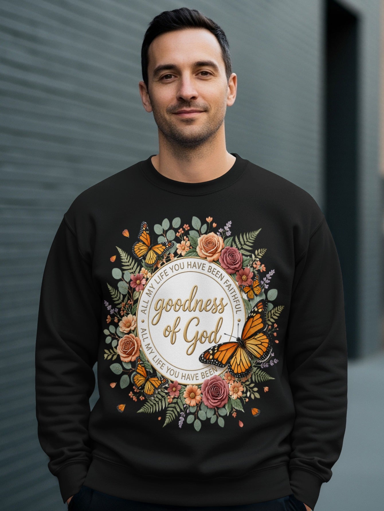 Black sweatshirt with floral wreath and "goodness of God" text.