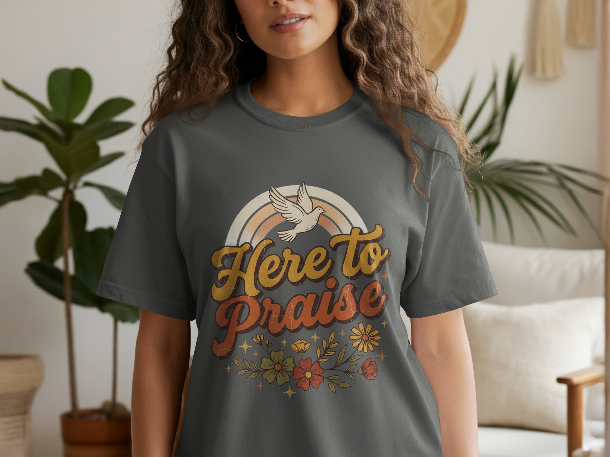Dark grey t-shirt with 'Here to Praise' text, a rainbow, and flowers.