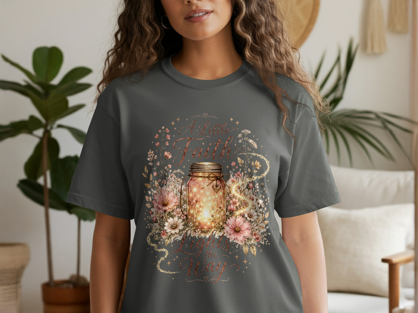 T-shirt with illuminated mason jar, flowers, and text "A Little Faith Lights the Way."