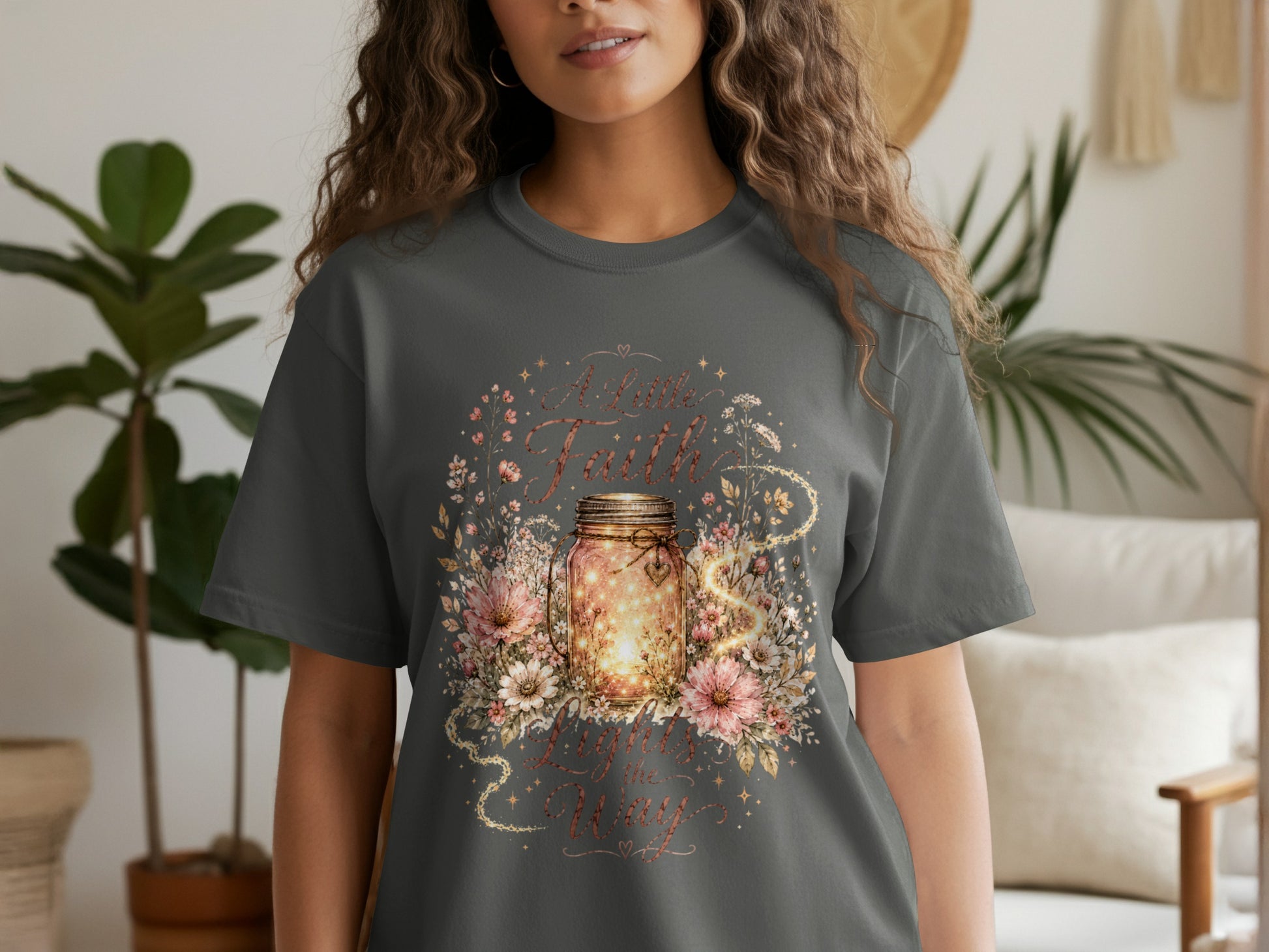 T-shirt with illuminated mason jar, flowers, and text "A Little Faith Lights the Way."